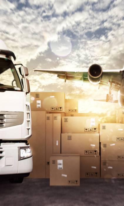 Truck and aircraft in a deposit with packages ready to start to deliver